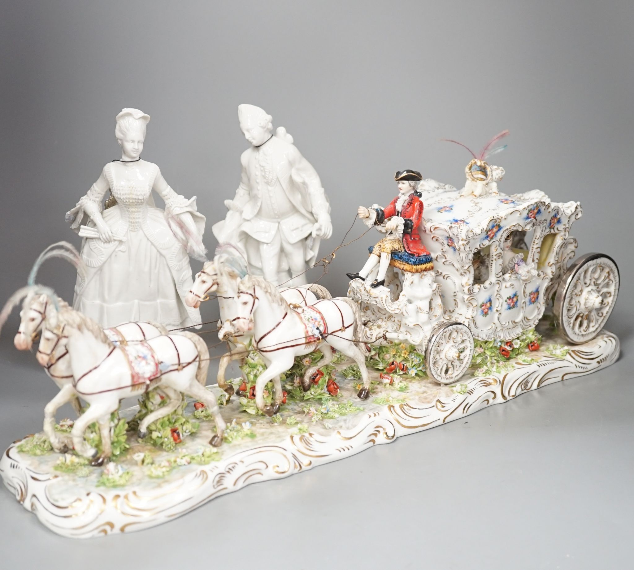 A large Italian porcelain carriage group and a pair of Italian white porcelain figure of a lady and a man 54cm